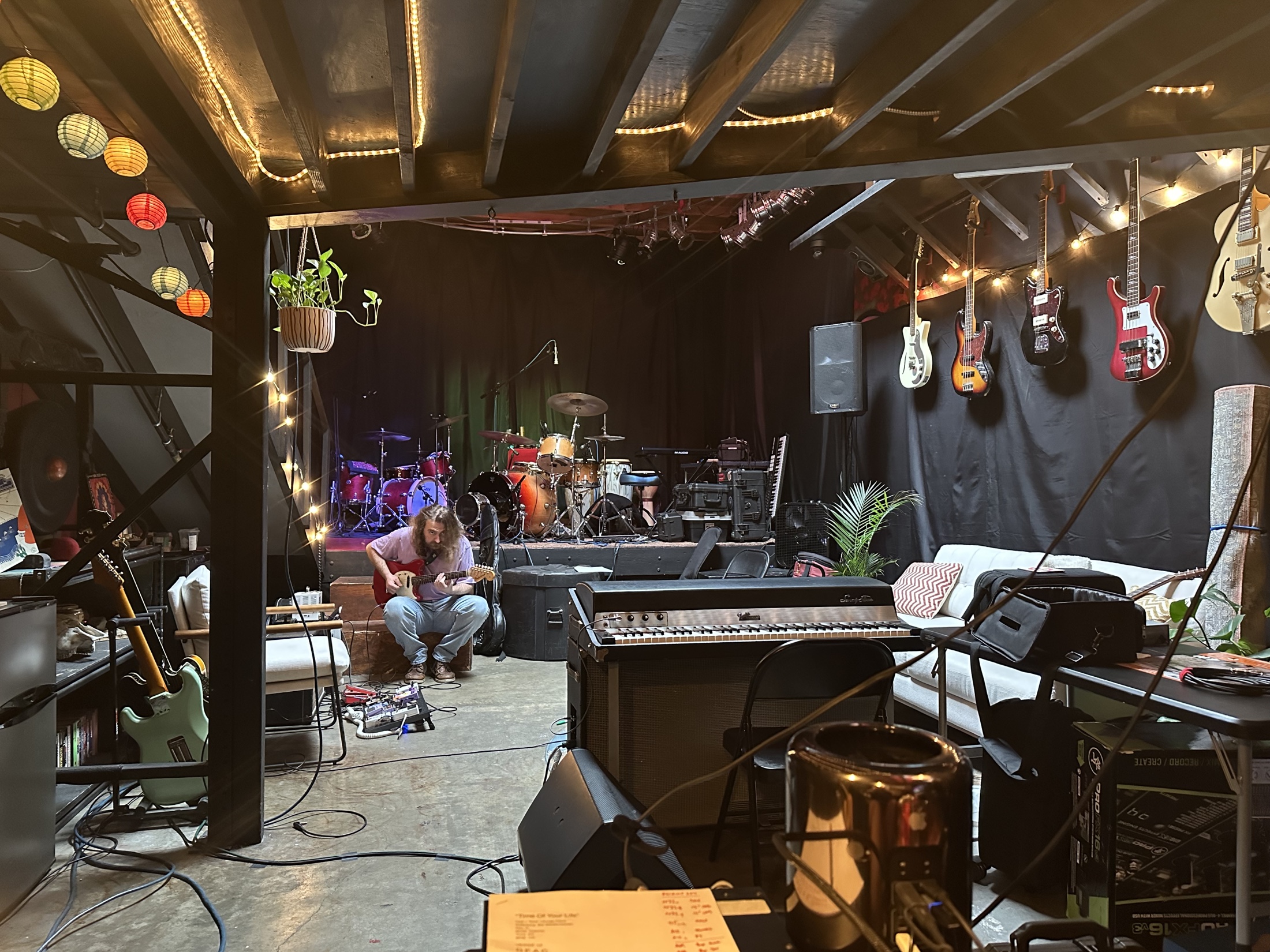A guitarist working in the Motel Media live room during a Taverna Project session