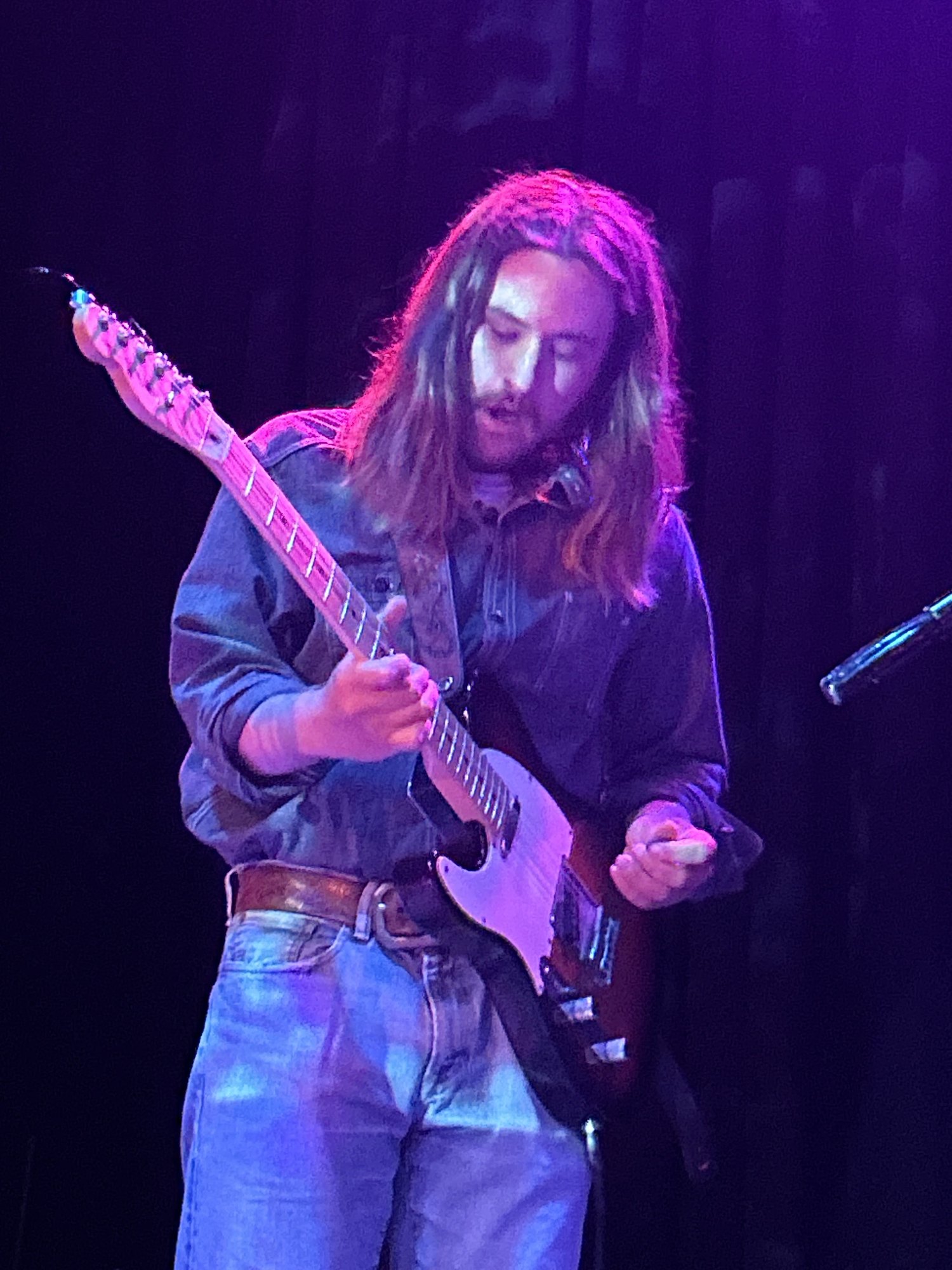 Matterform guitarist performing under blue and magenta stage lights at SOHO