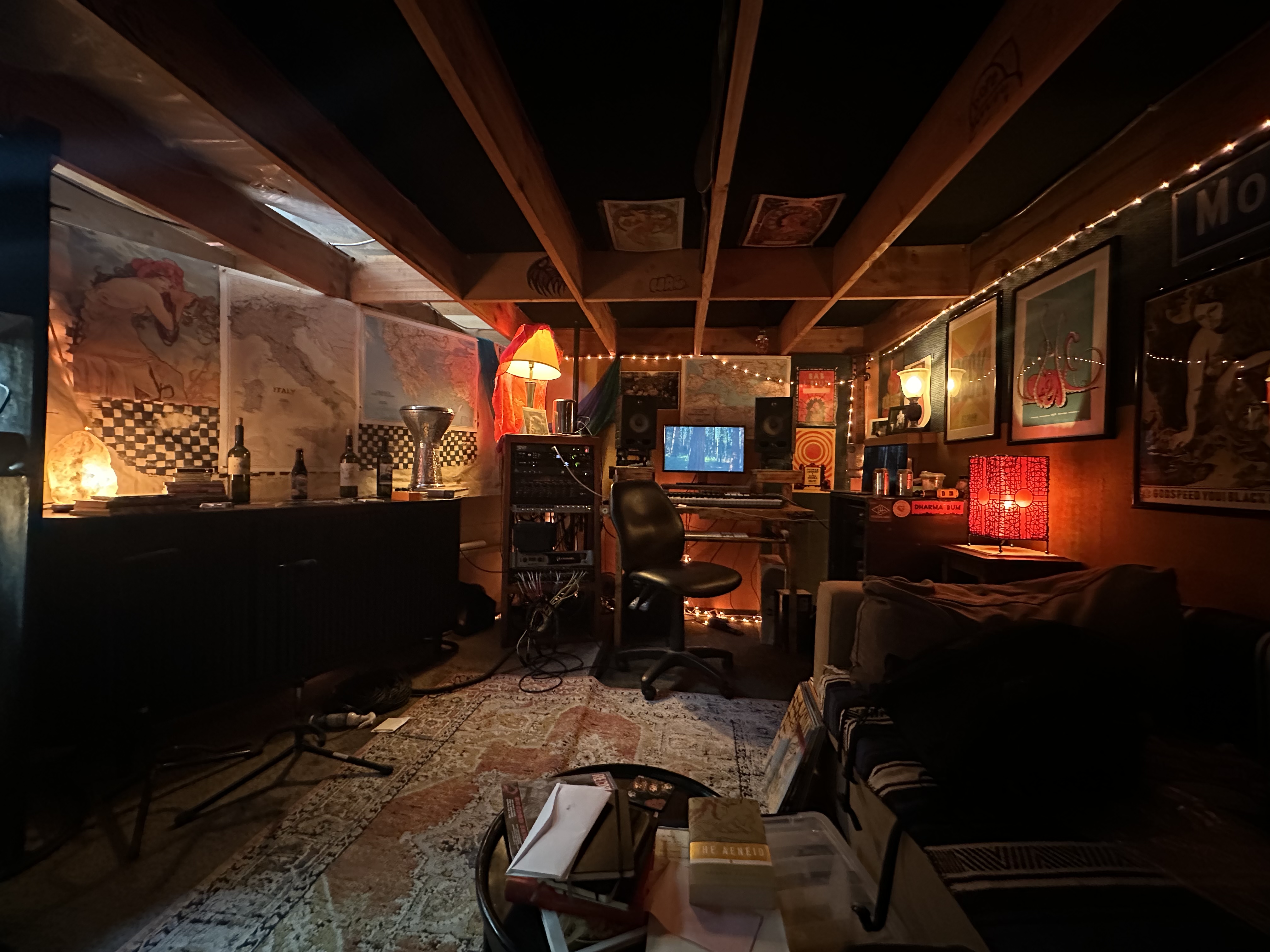 Motel Media control room with recording equipment, warm lamps, maps, and lounge seating